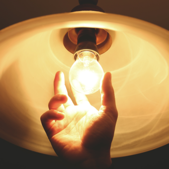 Hand changing lightbulb